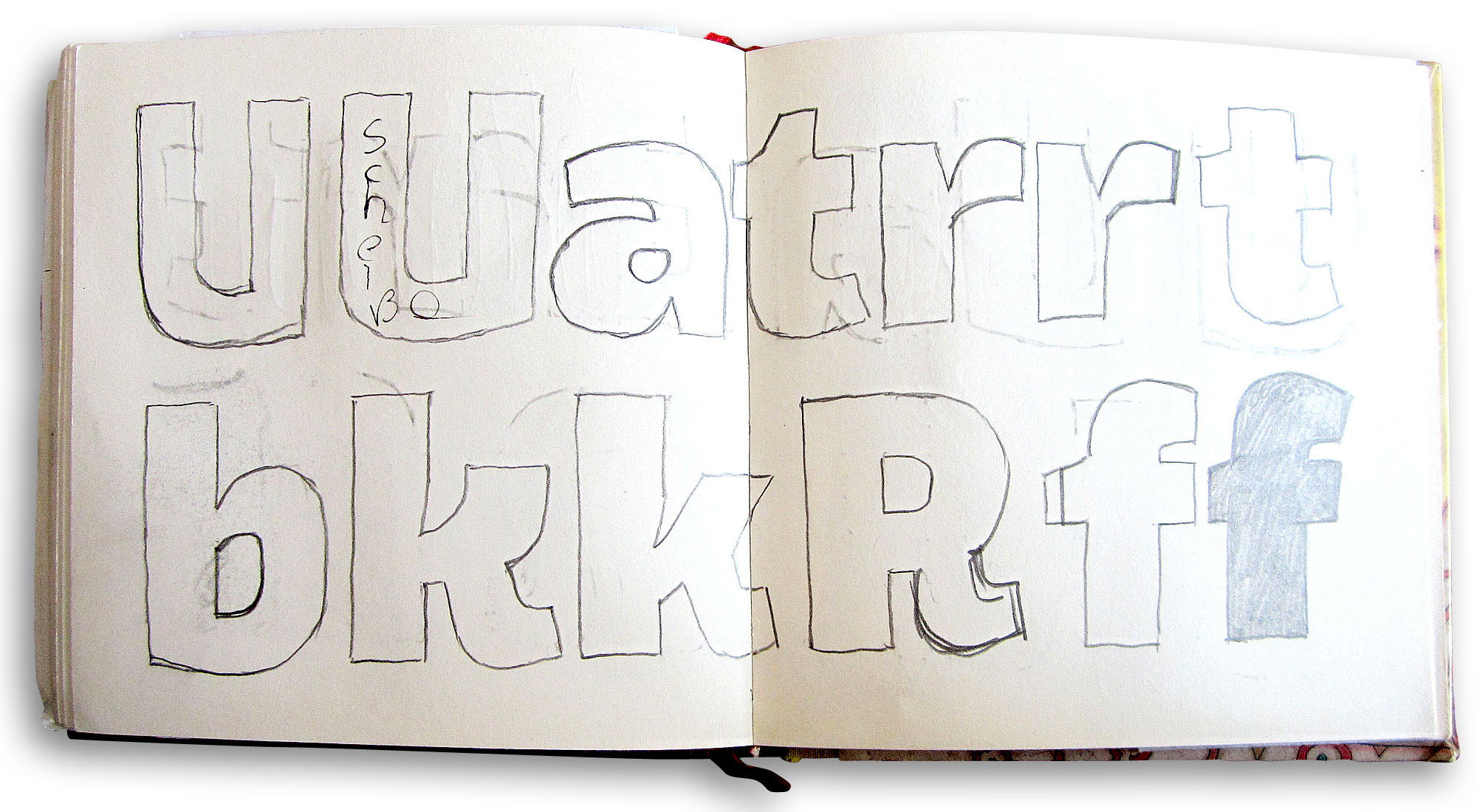 Manual sketches of letters in a sketchbook